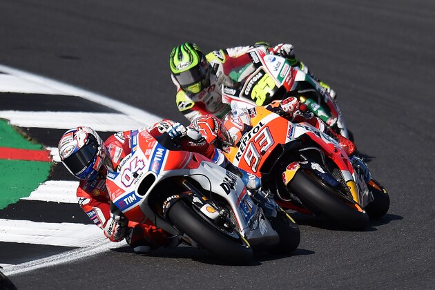 Ducati Team's Italian rider Andrea Dovizioso leads Repsol Honda Team's Spanish rider Marc Marquez during the MotoGP race of the British Grand Prix at Silverstone circuit in Northamptonshire, southern England, on August 27, 2017. / AFP PHOTO / Oli SCARFF        (Photo credit should read OLI SCARFF/AFP/Getty Images)