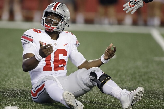 Ohio State quarterback J.T. Barrett looks up at an Indiana player after being hit on a pass during the first half of an NCAA college football game Thursday, Aug. 31, 2017, in Bloomington, Ind. (AP Photo/Darron Cummings)
