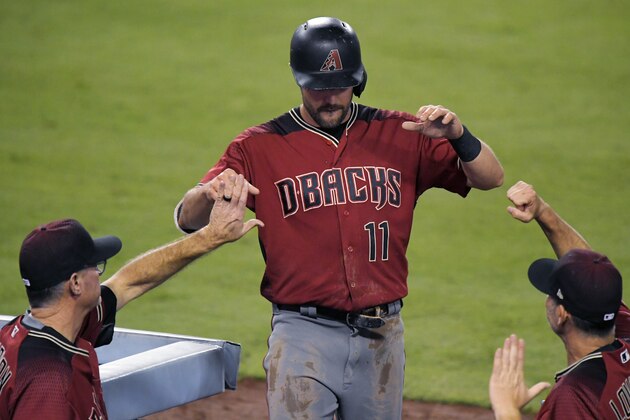 Arizona Diamondbacks' A.J. Pollock, center, is congratulated by manager Torey Lovullo, right, and interim bench coach Jerry Narron after scoring during the second inning of a baseball game against the Los Angeles Dodgers, Wednesday, Sept. 6, 2017, in Los Angeles. (AP Photo/Mark J. Terrill)