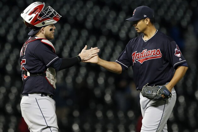 Cleveland Indians starting pitcher Carlos Carrasco, right, celebrates with catcher Roberto Perez after the Indians defeated the Chicago White Sox 5-1 in a baseball game Wednesday, Sept. 6, 2017, in Chicago. (AP Photo/Nam Y. Huh)