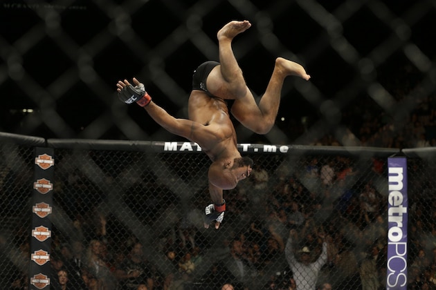 Demetrious Johnson flips during his main event fight with Chris Cariaso, Saturday, Sept. 27, 2014, in Las Vegas. Johnson won via submission. (AP Photo/John Locher)