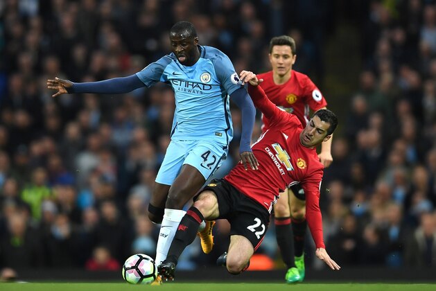 MANCHESTER, ENGLAND - APRIL 27:  Yaya Toure of Manchester City is tackled by Henrikh Mkhitaryan of Manchester United  during the Premier League match between Manchester City and Manchester United at Etihad Stadium on April 27, 2017 in Manchester, England.  (Photo by Laurence Griffiths/Getty Images)