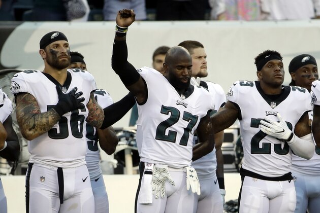 Philadelphia Eagles' Chris Long, left, and Rodney McLeod, right, put their arms on Malcolm Jenkins during the national anthem before a preseason NFL football game against the Miami Dolphins, Thursday, Aug. 24, 2017, in Philadelphia. (AP Photo/Matt Rourke)