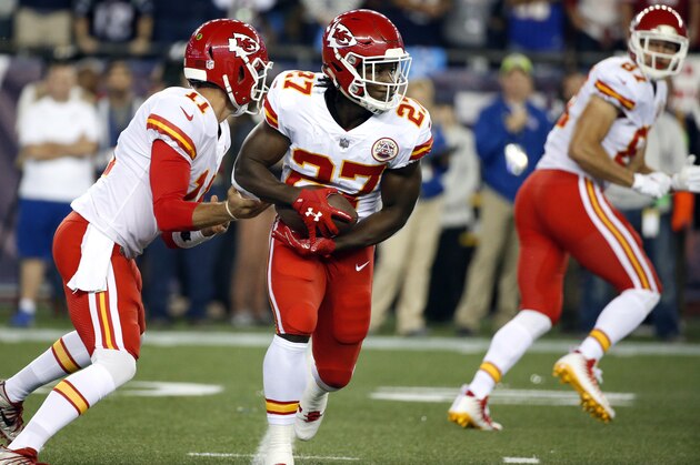 Kansas City Chiefs quarterback Alex Smith (11) hands off the ball to running back Kareem Hunt (27) during the first half of an NFL football game against the New England Patriots, Thursday, Sept. 7, 2017, in Foxborough, Mass. (AP Photo/Michael Dwyer)
