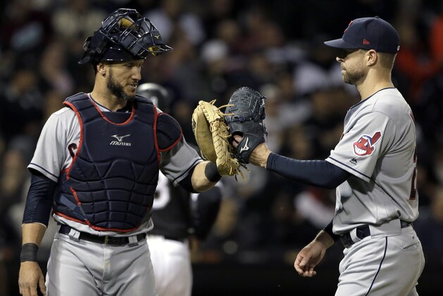 Cleveland Indians starting pitcher Corey Kluber, right, celebrates with catcher Yan Gomes as they walk to the dugout after the sixth inning of a baseball game against the Chicago White Sox, Thursday, Sept. 7, 2017, in Chicago. (AP Photo/Nam Y. Huh)