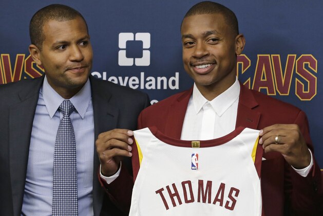 Cleveland Cavaliers' Isaiah Thomas, right, holds up his jersey as general manager Koby Altman looks on during a news conference at the NBA basketball teams practice facility, Thursday, Sept. 7, 2017, in Independence, Ohio. (AP Photo/Tony Dejak)