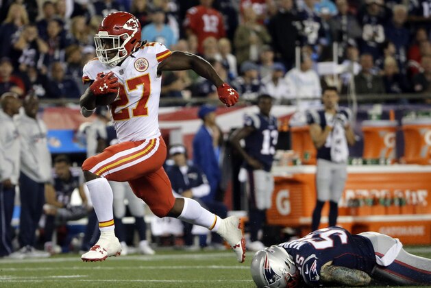 Kansas City Chiefs running back Kareem Hunt (27) eludes New England Patriots defensive end Cassius Marsh (55) as he runs for a touchdown after catching a pass from Alex Smith during the second half of an NFL football game, Thursday, Sept. 7, 2017, in Foxborough, Mass. (AP Photo/Steven Senne)