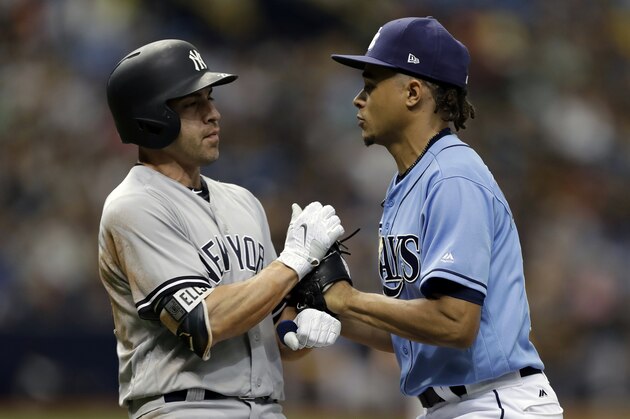 Tampa Bay Rays starting pitcher Chris Archer, right, tags out New York Yankees' Jacoby Ellsbury on a ground ball back to the mound during the sixth inning of a baseball game Sunday, May 21, 2017, in St. Petersburg, Fla. (AP Photo/Chris O'Meara)