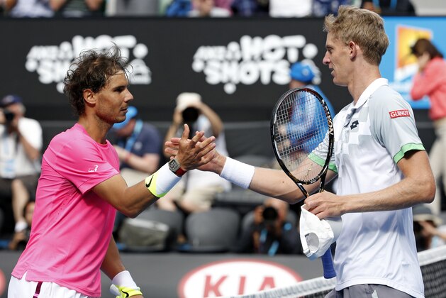 Rafael Nadal of Spain, left, shakes hands with Kevin Anderson of South Africa after winning their fourth round match at the Australian Open tennis championship in Melbourne, Australia, Sunday, Jan. 25, 2015. (AP Photo/Vincent Thian)