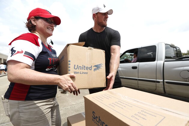 NFL Houston Texans defensive end J.J. Watt helps distribute relief supplies to people impacted by Hurricane Harvey on September 3, 2017, in Houston. 
Watt's Hurricane Harvey Relief Fund has raised more than $18 million to date to help those affected by the storm.  / AFP PHOTO / POOL / Brett Coomer        (Photo credit should read BRETT COOMER/AFP/Getty Images)
