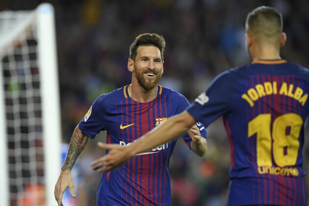 Barcelona's Argentinian forward Lionel Messi (L) celebrates with Barcelona's defender Jordi Alba after scoring his second goal during the Spanish Liga football match Barcelona vs Espanyol at the Camp Nou stadium in Barcelona on September 9, 2017. / AFP PHOTO / LLUIS GENE        (Photo credit should read LLUIS GENE/AFP/Getty Images)