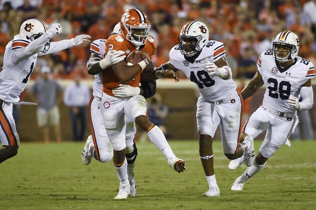 Clemson quarterback Kelly Bryant (2) runs for yardage as Auburn's Stephen Roberts (14), Marlon Davidson (3), Darrell Williams (49) and Tray Matthews (28) give chase during the second half of an NCAA college football game, Saturday, Sept. 9, 2017, in Clemson, S.C. Clemson won 14-6. (AP Photo/Rainier Ehrhardt)