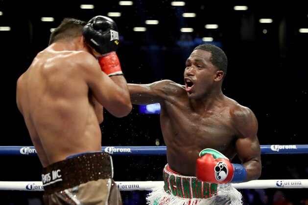 BROOKLYN, NY - JULY 29:  Adrien Broner punches Mikey Garcia during their Junior Welterwight bout on July 29, 2017 at the Barclays Center in the Brooklyn borough of  New York City.  (Photo by Elsa/Getty Images)