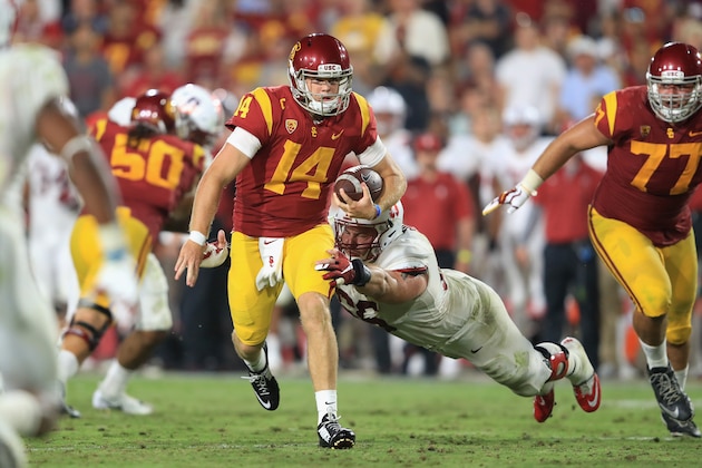 LOS ANGELES, CA - SEPTEMBER 09:  Harrison Phillips #66 of the Stanford Cardinal attempts to tackle Sam Darnold #14 of the USC Trojans during the fourth quarter at Los Angeles Memorial Coliseum on September 9, 2017 in Los Angeles, California.  (Photo by Sean M. Haffey/Getty Images)