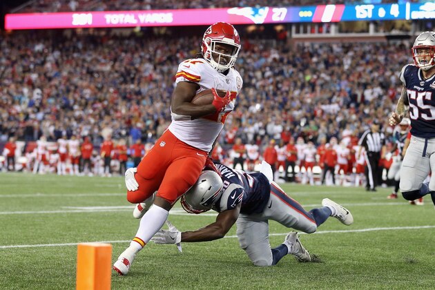 FOXBORO, MA - SEPTEMBER 07:  Kareem Hunt #27 of the Kansas City Chiefs runs for a 4-yard rushing touchdown as Duron Harmon #30 of the New England Patriots attempts to tackle him during the fourth quarter against the New England Patriots at Gillette Stadium on September 7, 2017 in Foxboro, Massachusetts.  (Photo by Maddie Meyer/Getty Images)