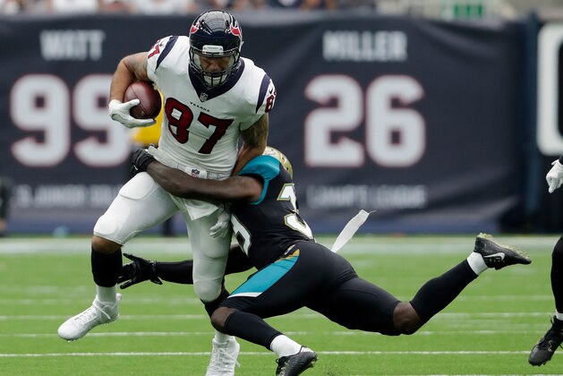 HOUSTON, TX - SEPTEMBER 10:  C.J. Fiedorowicz #87 of the Houston Texans catches a pass and is tackled by Tashaun Gipson #39 of the Jacksonville Jaguars in the second quarter at NRG Stadium on September 10, 2017 in Houston, Texas.  (Photo by Tim Warner/Getty Images)