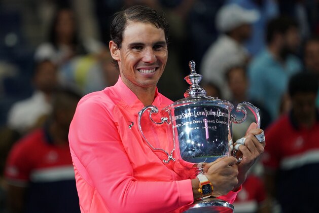 Spain's Rafael Nadal poses with his winning trophy after defeating South Africa's Kevin Anderson during their 2017 US Open Men's Singles final match at the USTA Billie Jean King National Tennis Center in New York on September 10, 2017. 
Rafael Nadal raced to a third US Open title and 16th Grand Slam crown on Sunday with a 6-3, 6-3, 6-4 rout of South African giant Kevin Anderson. / AFP PHOTO / DON EMMERT        (Photo credit should read DON EMMERT/AFP/Getty Images)