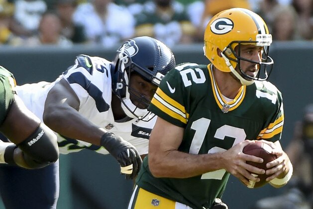 Sep 10, 2017; Green Bay, WI, USA;  Green Bay Packers quarterback Aaron Rodgers (12) is sacked by Seattle Seahawks defensive end Michael Bennett (72) in the second quarter at Lambeau Field. Mandatory Credit: Benny Sieu-USA TODAY Sports