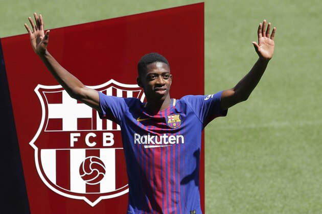 FILE  - In this Monday, Aug. 28, 2017 file photo, French soccer player Ousmane Dembele gestures during official presentation at the Camp Nou stadium in Barcelona, Spain. Dembele, the 20-year-old France striker signed by Barcelona to replace Neymar is expected to make his debut in the Catalan derby against Espanyol on Saturday, Sept. 9, 2017. (AP Photo/Manu Fernandez, File)