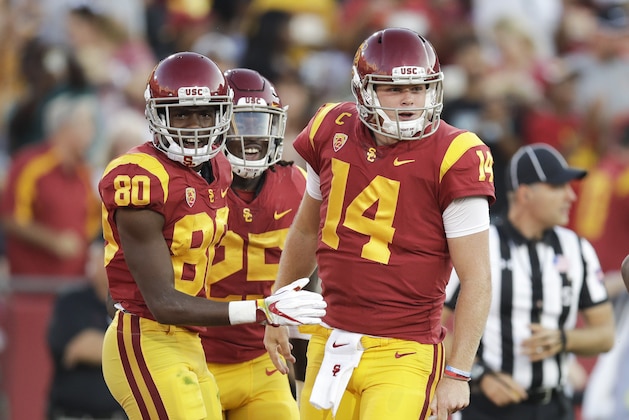 Southern California quarterback Sam Darnold, right, Deontay Burnett, left, and Ronald Jones II celebrate a touchdown by Burnett during the first half of an NCAA college football game against Stanford, Saturday, Sept. 9, 2017, in Los Angeles. (AP Photo/Jae C. Hong)
