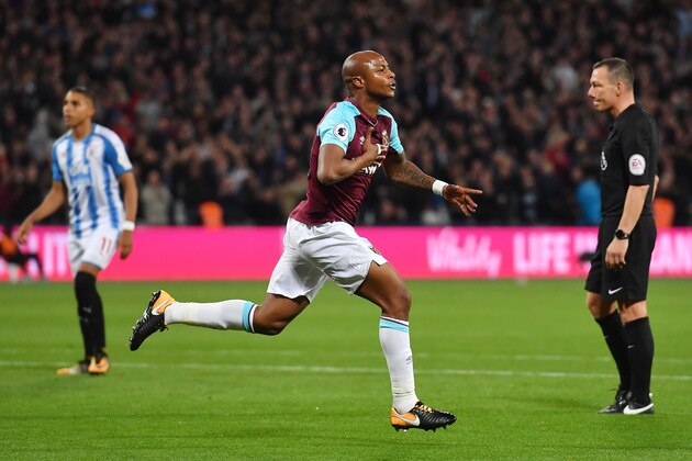 West Ham United's French-born Ghanaian midfielder Andre Ayew (C) celebrates after scoring their second goal during the English Premier League football match between West Ham United and Huddersfield Town at The London Stadium, in east London on September 11, 2017. / AFP PHOTO / Ben STANSALL / RESTRICTED TO EDITORIAL USE. No use with unauthorized audio, video, data, fixture lists, club/league logos or 'live' services. Online in-match use limited to 75 images, no video emulation. No use in betting, games or single club/league/player publications.  /         (Photo credit should read BEN STANSALL/AFP/Getty Images)
