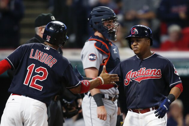 Cleveland Indians' Jose Ramirez gets congratulations from Francisco Lindor (12) after hitting a two run home run off Detroit Tigers starting pitcher Myles Jaye as catcher James McCann stands in the background during the fourth inning in a baseball game, Monday, Sept. 11, 2017, in Cleveland. (AP Photo/Ron Schwane)