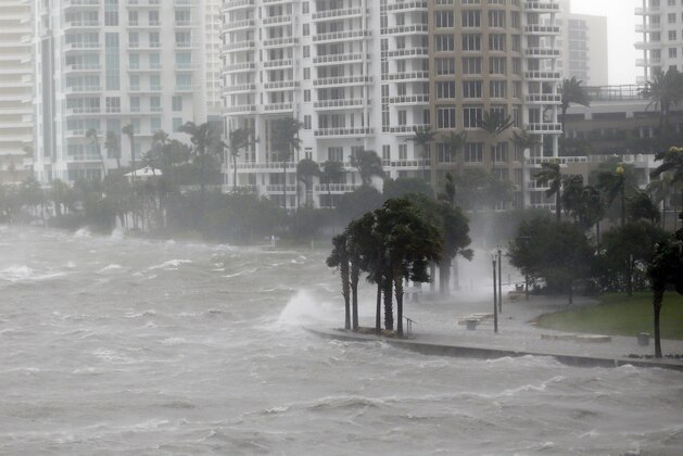 Waves crash over a seawall at the mouth of the Miami River from Biscayne Bay, Fla., as Hurricane Irma passes by, Sunday, Sept. 10, 2017, in Miami.  (AP Photo/Wilfredo Lee)
