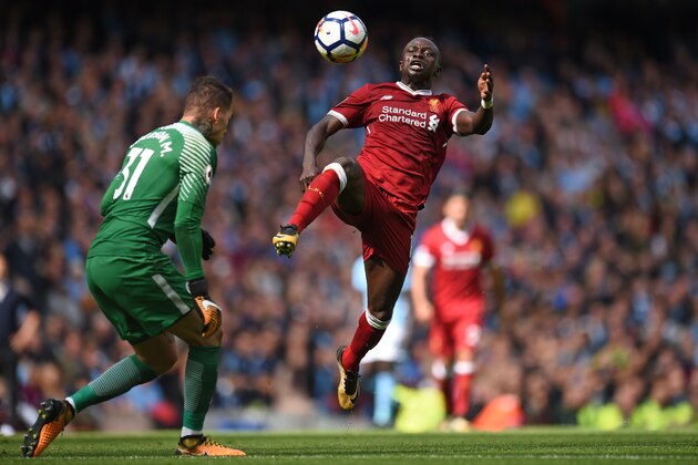 Liverpool's Senegalese midfielder Sadio Mane (R) is sent off for this challenge on Manchester City's Brazilian goalkeeper Ederson during the English Premier League football match between Manchester City and Liverpool at the Etihad Stadium in Manchester, north west England, on September 9, 2017. / AFP PHOTO / Oli SCARFF / RESTRICTED TO EDITORIAL USE. No use with unauthorized audio, video, data, fixture lists, club/league logos or 'live' services. Online in-match use limited to 75 images, no video emulation. No use in betting, games or single club/league/player publications.  /         (Photo credit should read OLI SCARFF/AFP/Getty Images)