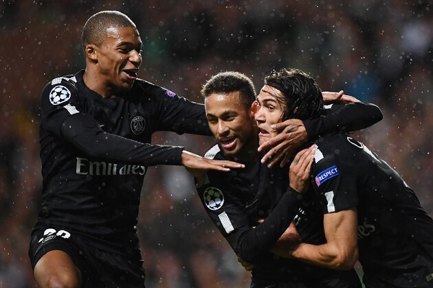 Paris Saint-Germain's Brazilian striker Neymar (C) celebrates with Paris Saint-Germain's French striker Kylian Mbappe (L) and Paris Saint-Germain's Uruguayan striker Edinson Cavani (R) after scoring the opening goal of the UEFA Champions League Group B football match between Celtic and Paris Saint-Germain (PSG) at Celtic Park in Glasgow, on September 12, 2017. / AFP PHOTO / FRANCK FIFE        (Photo credit should read FRANCK FIFE/AFP/Getty Images)