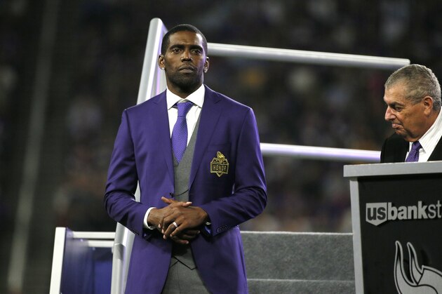 Former Minnesota Vikings wide receiver Randy Moss, left, looks on as he is inducted into the Vikings Ring of Honor during halftime of an NFL football game between the Vikings and the New Orleans Saints, Monday, Sept. 11, 2017, in Minneapolis. (AP Photo/Bruce Kluckhohn)