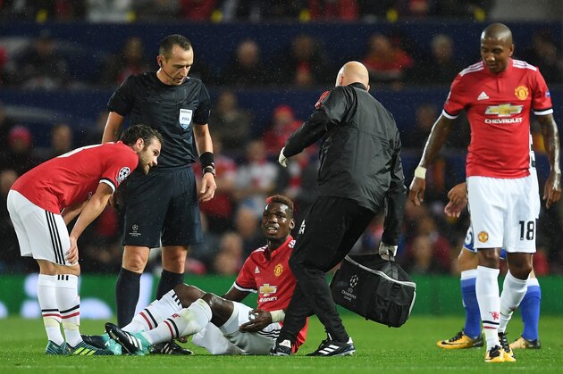 MANCHESTER, ENGLAND - SEPTEMBER 12: Paul Pogba of Manchester United receives treatment from the medical team during the UEFA Champions League Group A match between Manchester United and FC Basel at Old Trafford on September 12, 2017 in Manchester, United Kingdom.  (Photo by Laurence Griffiths/Getty Images)