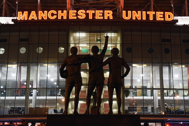 A general view outside Old Trafford stadium and 'The United Trinity' statue of former Manchester United players George Best, Denis Law, and Bobby Charlton seen ahead of the English Premier League football match between Manchester United and Burnley at Old Trafford in Manchester, north west England, on February 11, 2015.  AFP PHOTO / OLI SCARFF

RESTRICTED TO EDITORIAL USE. No use with unauthorized audio, video, data, fixture lists, club/league logos or live services. Online in-match use limited to 45 images, no video emulation. No use in betting, games or single club/league/player publications.        (Photo credit should read OLI SCARFF/AFP/Getty Images)