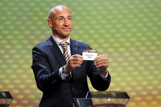 Swedish football coach Henrik Larsson shows the sheet of paper bearing the name of the Arsenal FC football team as he proceeds to the draw for the UEFA Europa League football group stage 2017/18 on August 25, 2017 in Monaco.  / AFP PHOTO / VALERY HACHE        (Photo credit should read VALERY HACHE/AFP/Getty Images)