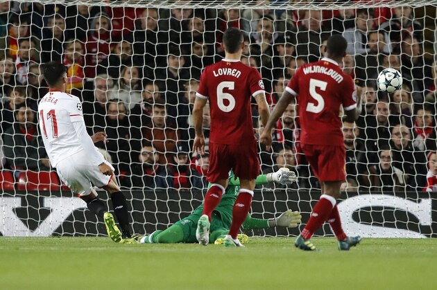 Sevilla's Joaquin Correa, left, scores a goal during the Champions League group E soccer match between Liverpool and Sevilla at Anfield stadium in Liverpool, England, Wednesday, Sept. 13, 2017. (AP Photo/Frank Augstein)