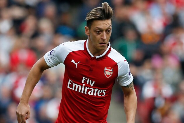 Arsenal's German midfielder Mesut Ozil runs with the ball during the English Premier League football match between Arsenal and Bournemouth at the Emirates Stadium in London on September 9, 2017. / AFP PHOTO / Ian KINGTON / RESTRICTED TO EDITORIAL USE. No use with unauthorized audio, video, data, fixture lists, club/league logos or 'live' services. Online in-match use limited to 75 images, no video emulation. No use in betting, games or single club/league/player publications.  /         (Photo credit should read IAN KINGTON/AFP/Getty Images)