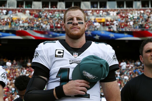 Philadelphia Eagles quarterback Carson Wentz stands on the sideline during a rendition of the national anthem before an NFL football game against the Washington Redskins, Sunday, Sept. 10, 2017, in Landover, Md. (AP Photo/Alex Brandon)