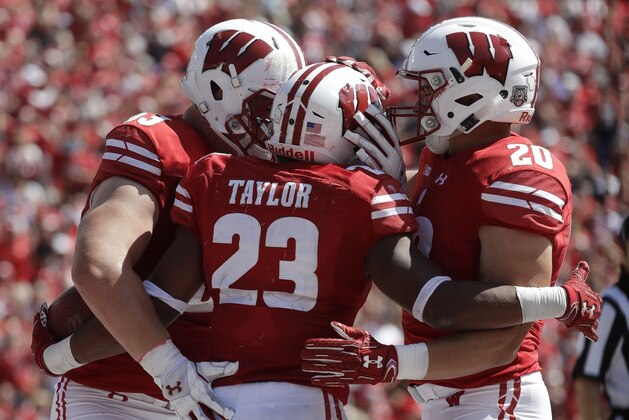 Wisconsin's Jonathan Taylor (23) celebrates his touchdown run with teammates Michael Deiter and Austin Ramesh (20) during the second half of an NCAA college football game against Florida Atlantic Saturday, Sept. 9, 2017, in Madison, Wis. Wisconsin won 31-14. (AP Photo/Morry Gash)