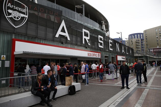 Fans arrive outside the ground ahead of the English Premier League football match between Arsenal and Leicester City at the Emirates Stadium in London on August 11, 2017.  / AFP PHOTO / Ian KINGTON / RESTRICTED TO EDITORIAL USE. No use with unauthorized audio, video, data, fixture lists, club/league logos or 'live' services. Online in-match use limited to 75 images, no video emulation. No use in betting, games or single club/league/player publications.  /         (Photo credit should read IAN KINGTON/AFP/Getty Images)