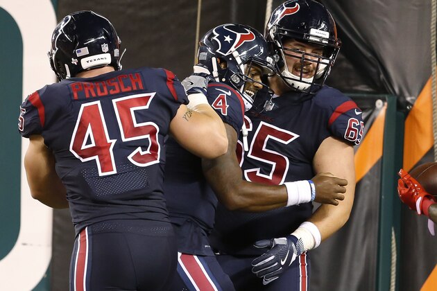 Houston Texans quarterback Deshaun Watson (4) celebrates with center Greg Mancz (65) and fullback Jay Prosch (45) after scoring a touchdown during the first half of an NFL football game against the Cincinnati Bengals, Thursday, Sept. 14, 2017, in Cincinnati. (AP Photo/Gary Landers)