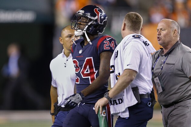 Houston Texans cornerback Johnathan Joseph (24) is helped off the field after an apparent injury during the first half of an NFL football game against the Cincinnati Bengals, Thursday, Sept. 14, 2017, in Cincinnati. (AP Photo/Gary Landers)