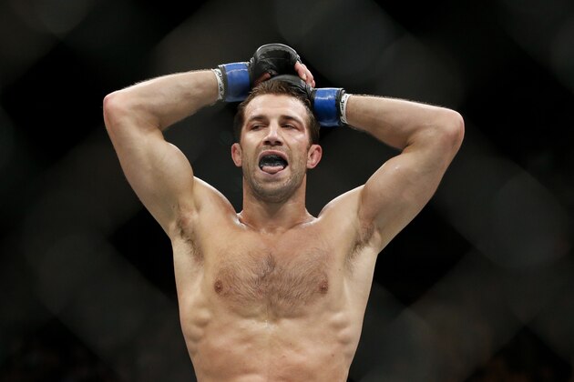 Luke Rockhold rests between rounds as he fights Chris Weidman in a middleweight  championship mixed martial arts bout at UFC 194, Saturday, Dec. 12, 2015, in Las Vegas. (AP Photo/John Locher)