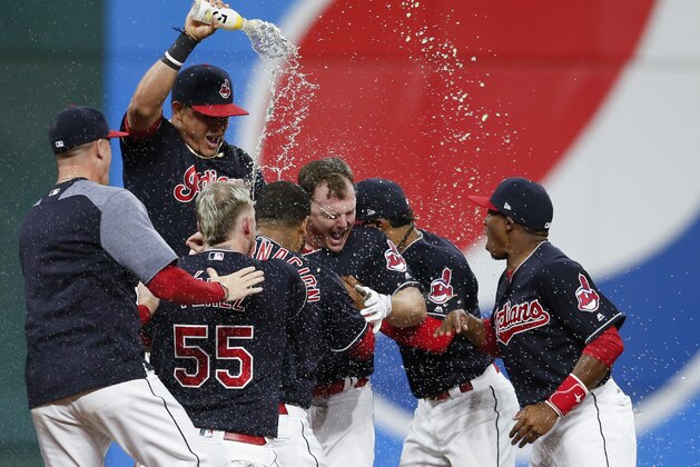 CLEVELAND, OH - SEPTEMBER 14: Jay Bruce #32 of the Cleveland Indians celebrates with teammates after hitting a game winning single off Brandon Maurer #32 of the Kansas City Royals during the tenth inning at Progressive Field on September 14, 2017 in Cleveland, Ohio. The Indians defeated the Royals 3-2 for their 22nd win in a row, an MLB record. (Photo by Ron Schwane/Getty Images)