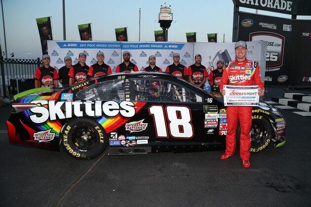 JOLIET, IL - SEPTEMBER 15:  Kyle Busch, driver of the #18 Skittles Sweet Heat Toyota, and his team pose with the Coors Light Pole Award after qualifying in the pole position for the Monster Energy NASCAR Cup Series Tales of the Turtles 400 at Chicagoland Speedway on September 15, 2017 in Joliet, Illinois.  (Photo by Sean Gardner/Getty Images)