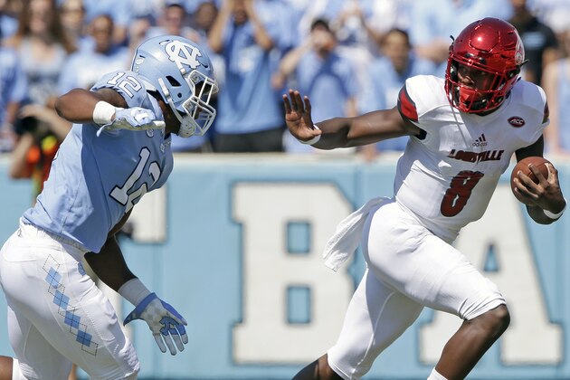 FILE - In this Sept. 9, 2017, file photo, Louisville quarterback Lamar Jackson (8) runs the ball as North Carolina's Tomon Fox (12) chases him during the first half of an NCAA college football game, in Chapel Hill, N.C. Fourteenth-ranked Louisville is looking for defensive improvement against No. 3 Clemson along with big numbers by quarterback Lamar Jackson on Saturday.  (AP Photo/Gerry Broome, File)