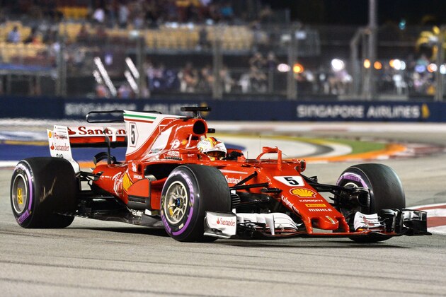 Ferrari's German driver Sebastian Vettel drives during the qualifying session of the Formula One Singapore Grand Prix in Singapore on September 16, 2017.  / AFP PHOTO / Roslan RAHMAN        (Photo credit should read ROSLAN RAHMAN/AFP/Getty Images)