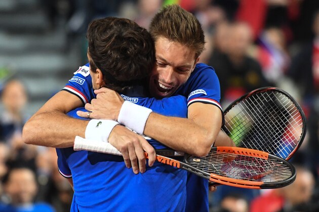 France's Nicolas Mahut celebrates with Pierre-Hugues Herbert (back) after winning their Davis Cup semi-final tennis match against Serbia at the Pierre Mauroy Stadium in Lille, northern France, on September 16, 2017.   / AFP PHOTO / DENIS CHARLET        (Photo credit should read DENIS CHARLET/AFP/Getty Images)