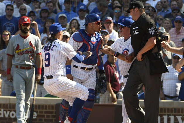 CHICAGO, IL - SEPTEMBER 15: Willson Contreras #40 of the Chicago Cubs is restrained by Javier Baez #9 of the Chicago Cubs as he was thrown out of the game umpire Jordan Baker #71 on September 15, 2017 at Wrigley Field  in Chicago, Illinois. (Photo by David Banks/Getty Images)