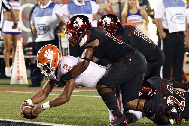 Clemson quarterback Kelly Bryant (2) is brought down by Louisville's Dorian Etheridge, front right, and Trumaine Washington (15) as he crosses the goal line during the first half of an NCAA college football game, Saturday, Sept. 16, 2017, in Louisville, Ky. (AP Photo/Timothy D. Easley)