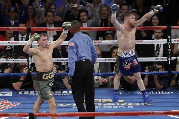 Canelo Alvarez, right, and Gennady Golovkin celebrate following a middleweight title fight Sunday, Sept. 17, 2017, in Las Vegas. The fight was called a draw. (AP Photo/Isaac Brekken)