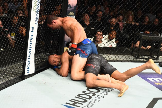 PITTSBURGH, PA - SEPTEMBER 16:  (L-R) Luke Rockhold controls the body and punches David Branch in their middleweight bout during the UFC Fight Night event inside the PPG Paints Arena on September 16, 2017 in Pittsburgh, Pennsylvania. (Photo by Josh Hedges/Zuffa LLC/Zuffa LLC via Getty Images)
